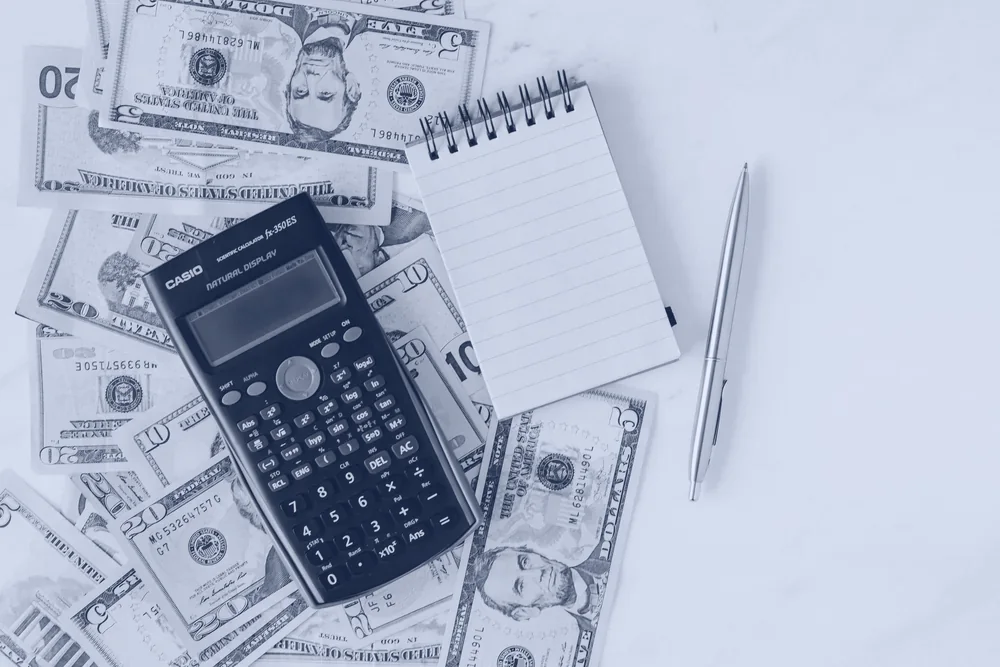 Calculator resting on US banknotes